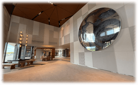 ホテルニッコースタイルニセコHANAZONOのエントランス。大きな丸い鏡のような壁掛けが際立つ。テーブルやいすがあり、広い。